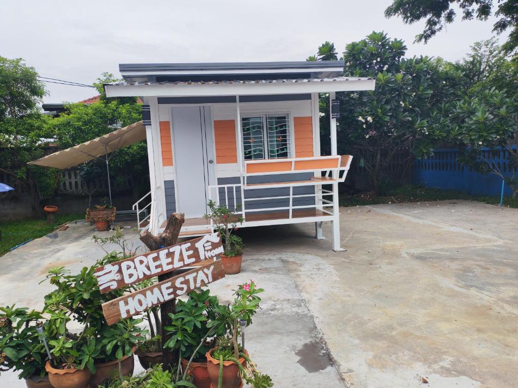 a small house with a sign in front of it at Breeze Homestay in Nong Khai