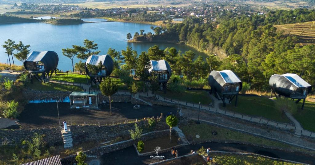 an aerial view of a group of tents next to a lake at Valahara Eco-Luxury Camp in Antsirabe