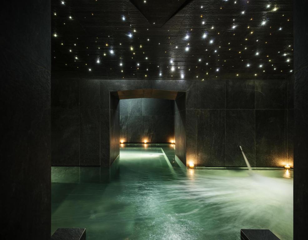 a pool of water in a dark room with lights at Hyatt Centric Milan Centrale in Milan