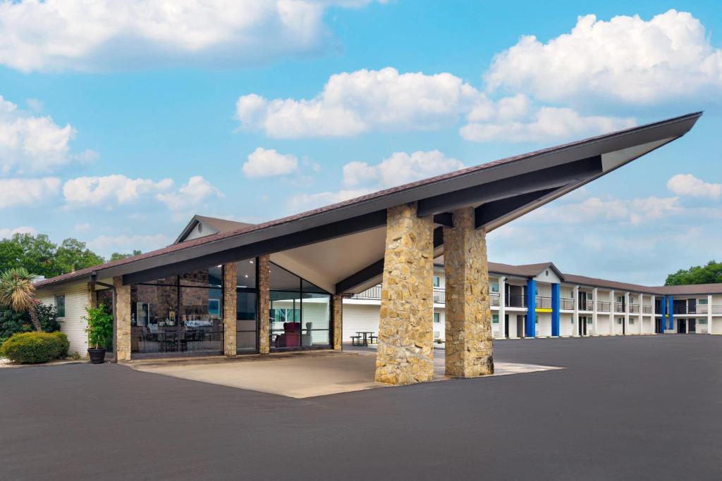 a rendering of a building with a large roof at Days Inn by Wyndham Gatesville in Gatesville