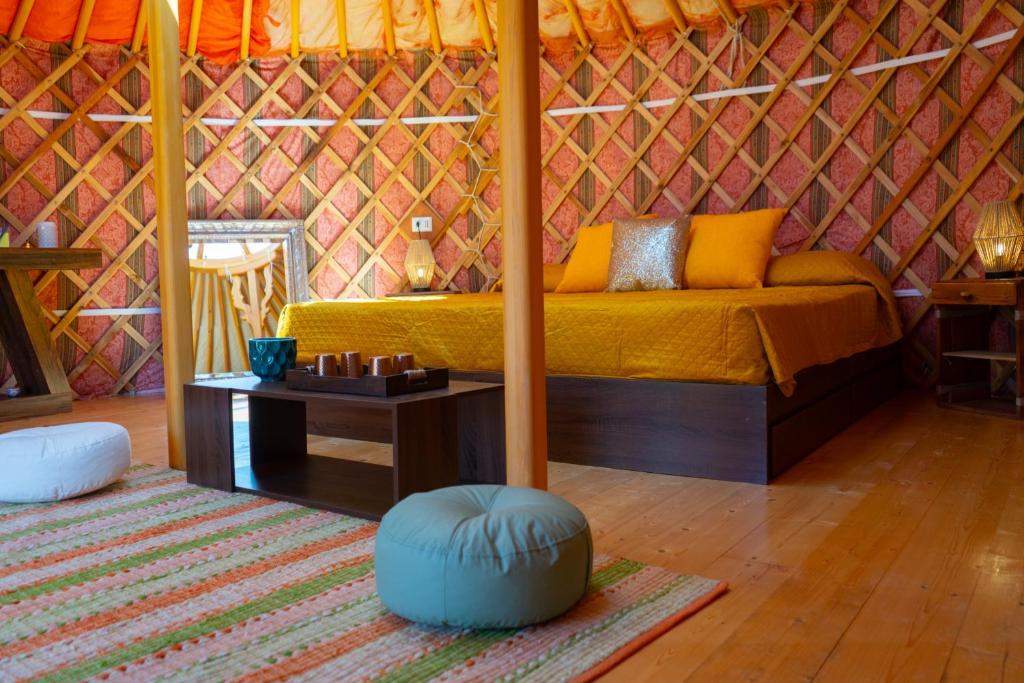 a room with a bed and a table in a tent at Podere Sorrentino in Offida