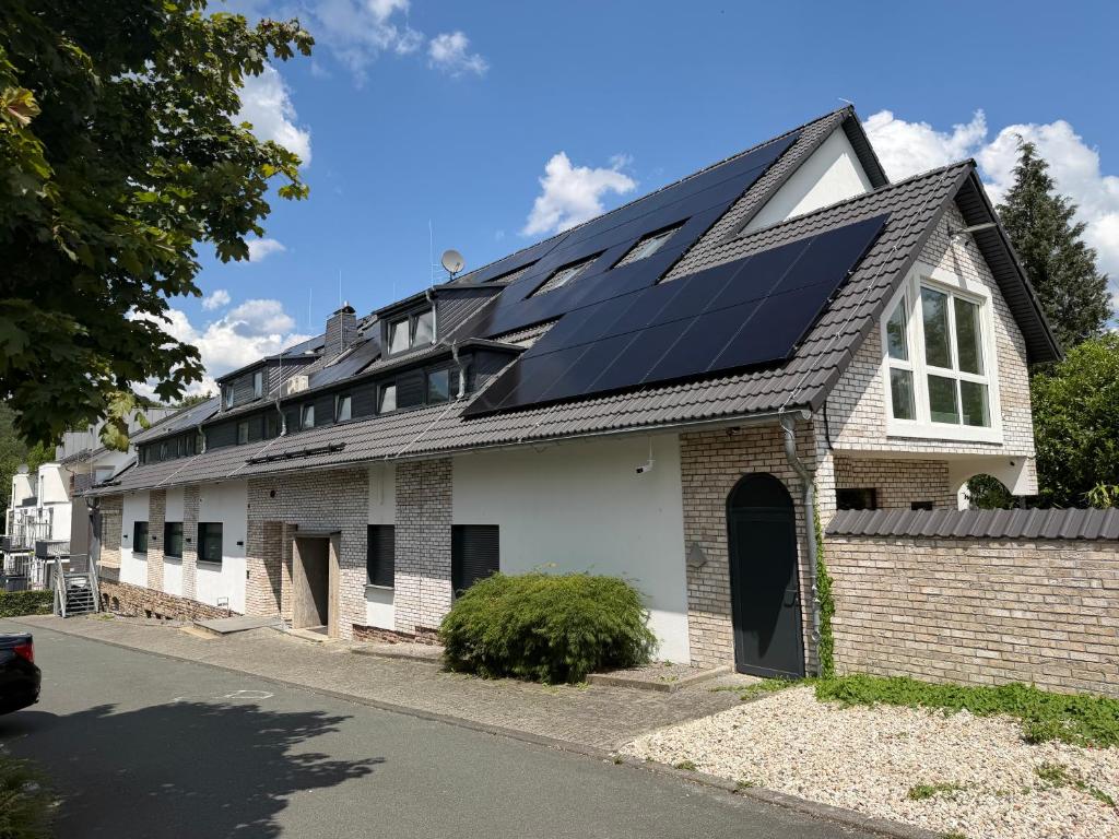 a house with solar panels on the roof at Elion Hotel Siegen in Siegen