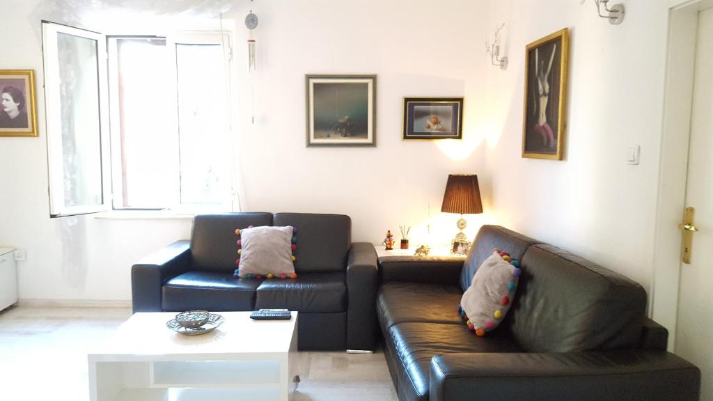 a living room with two leather couches and a table at Apartment Kiki in Kotor