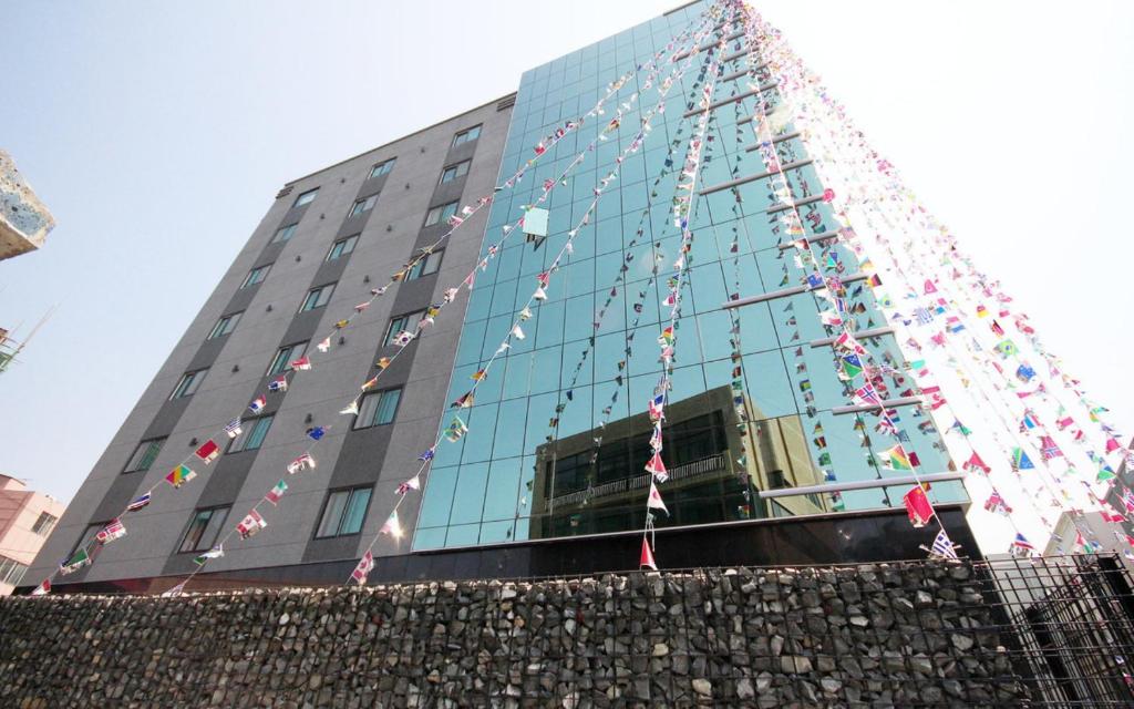 a building with a christmas tree in front of it at Ulsan Seongnam Hotel Mar in Ulsan