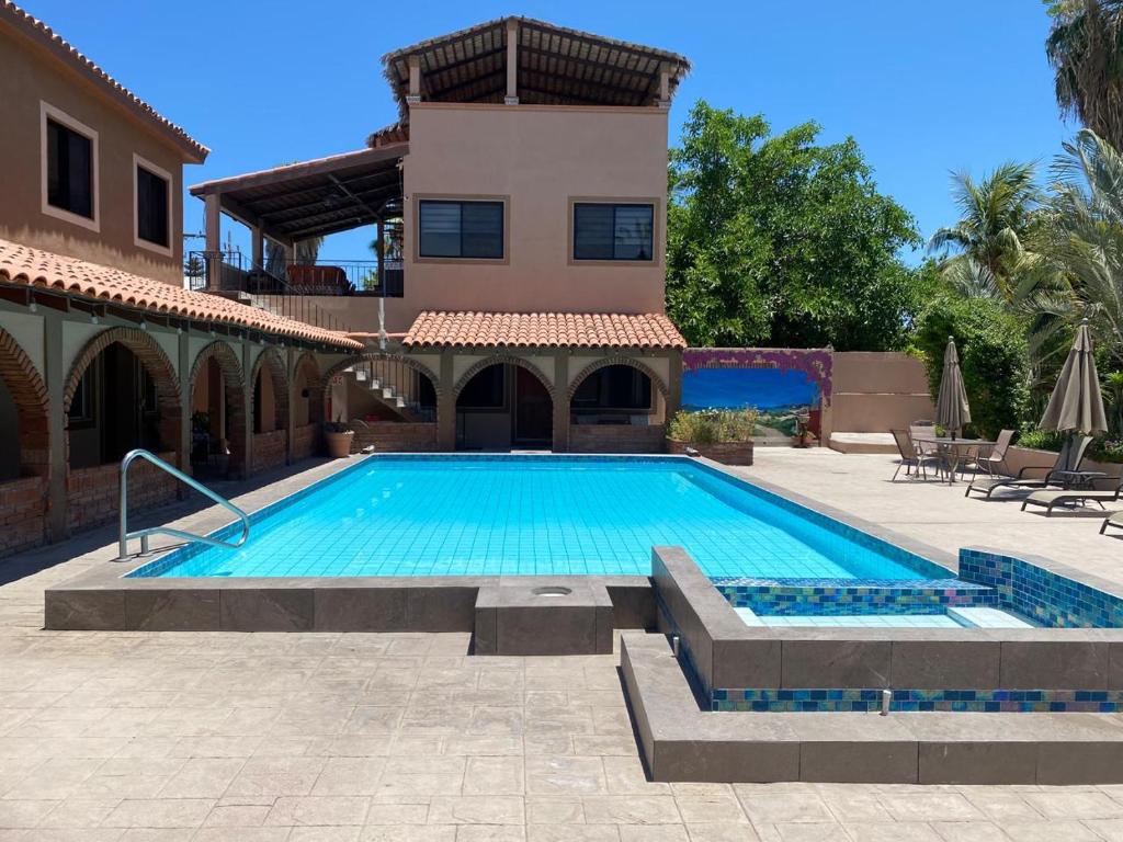 a swimming pool in front of a house at Loreto Playa Boutique Hotel in Loreto