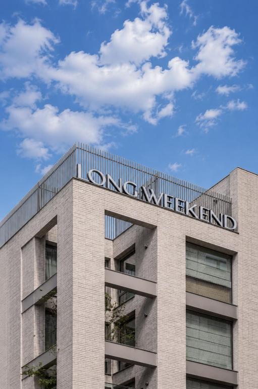 a building with a sign on the top of it at Long Weekend Haus in Seoul