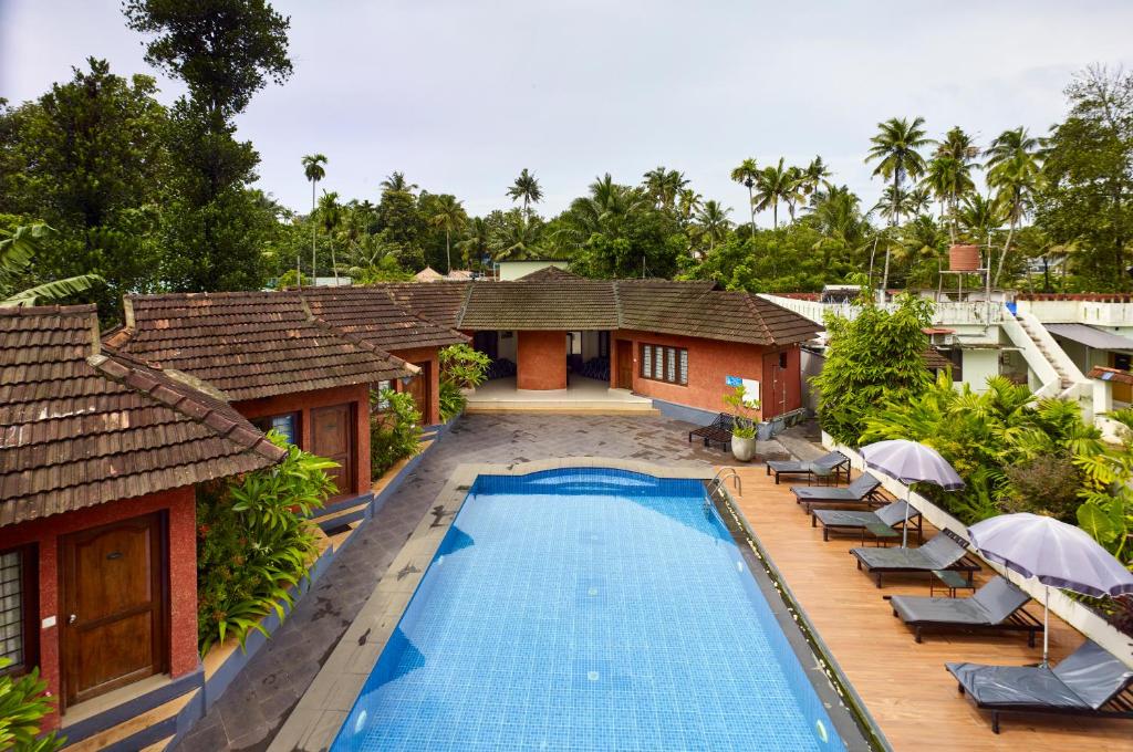 an aerial view of a resort with a swimming pool at Deshadan Cliff & Beach Resort,Varkala in Varkala