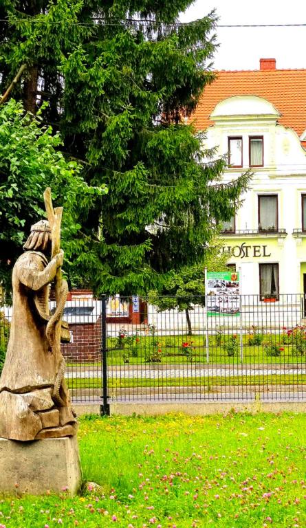 a statue of a person in front of a building at Bike Hostel&Camp in Przewóz