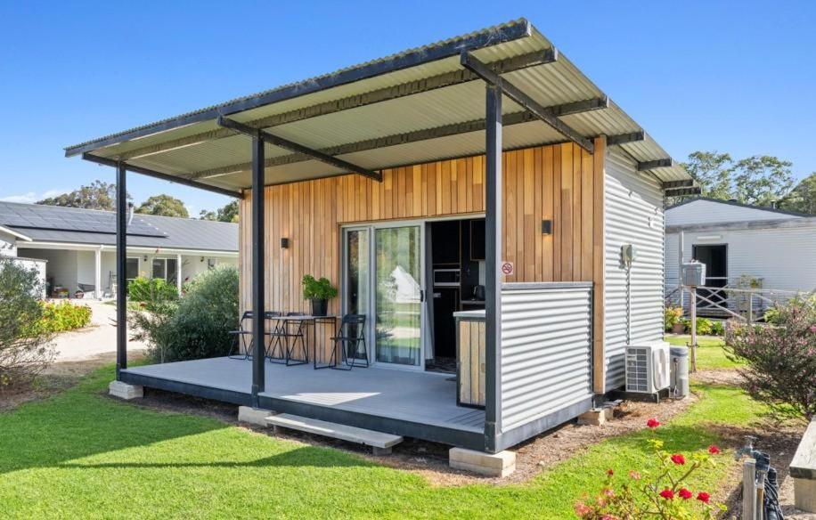 a shed with a deck in a yard at Trackside Tiny Home in Augusta