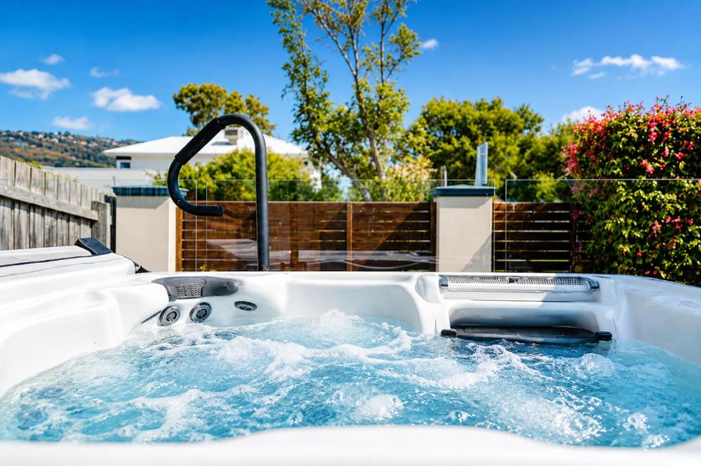 a jacuzzi tub in the backyard of a house at Solander in Dromana with Private Spa by Ready Set Stay in Dromana
