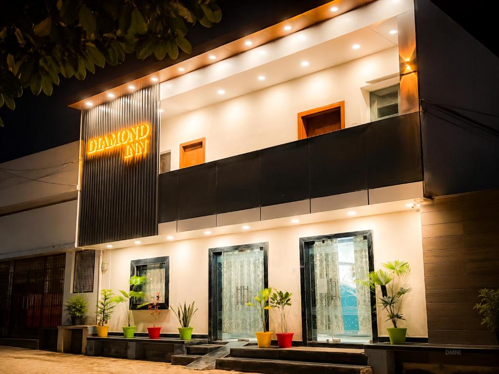 a building with a sign on the side of it at Hotel Diamond inn Mathura in Mathura