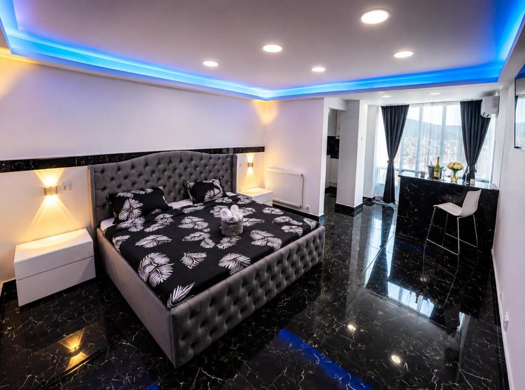 a bedroom with a bed in a room with blue lights at Yoa apartaments in Deva