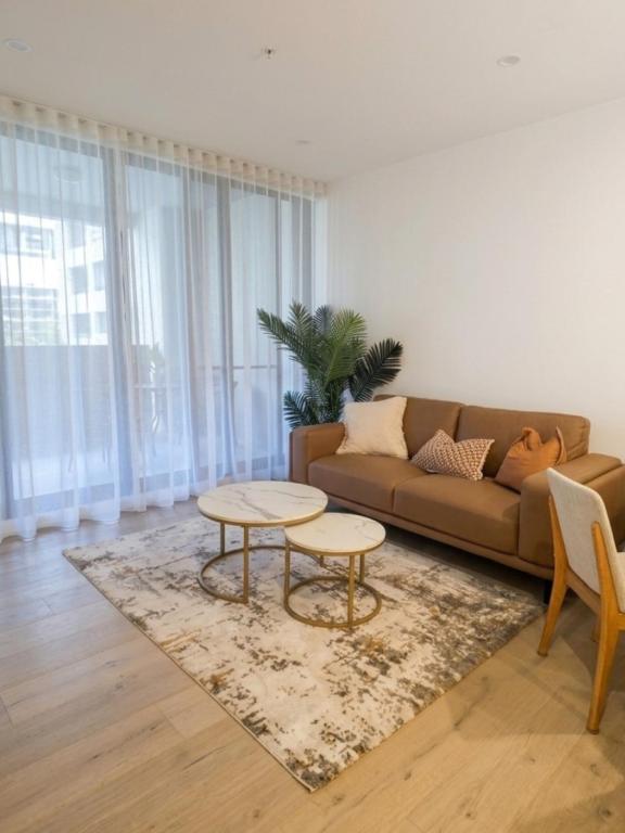 a living room with a couch and a table at 2BR Elevated Living Suite in Campbell