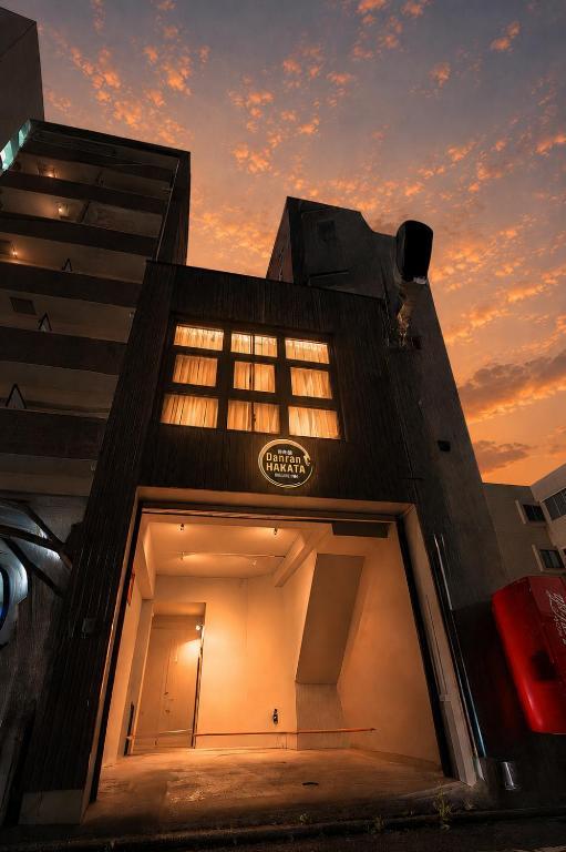a building with a window with a sunset in the background at Danran HAKATA in Fukuoka