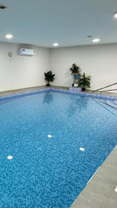 a large blue swimming pool in a building at Al Hawli pool gathering in Salalah