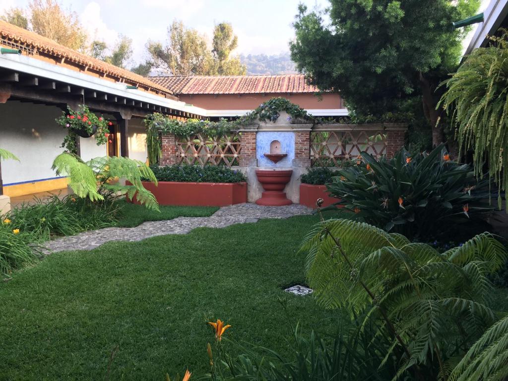 a garden with a fountain in the middle of a yard at Antigua Guatemala Villas in Antigua Guatemala