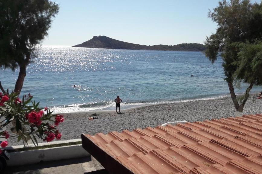 a person standing on a beach near the water at Argo Studios in Myrties