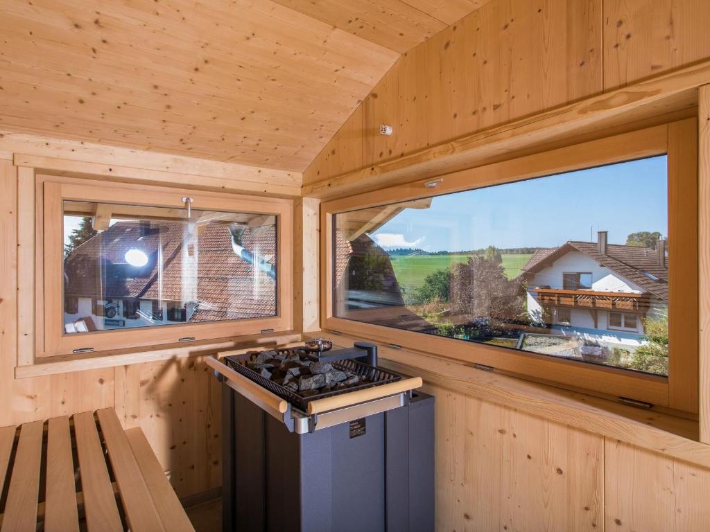 a kitchen in a tiny house with two windows at Saunaloft Schwarzwald in Gemeinde Aichhalden