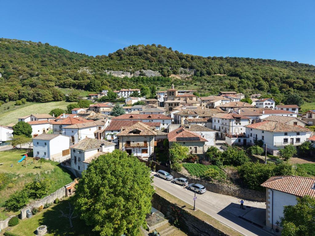 a village on a hill with cars parked at Casa Nabarro in Iturgoyen