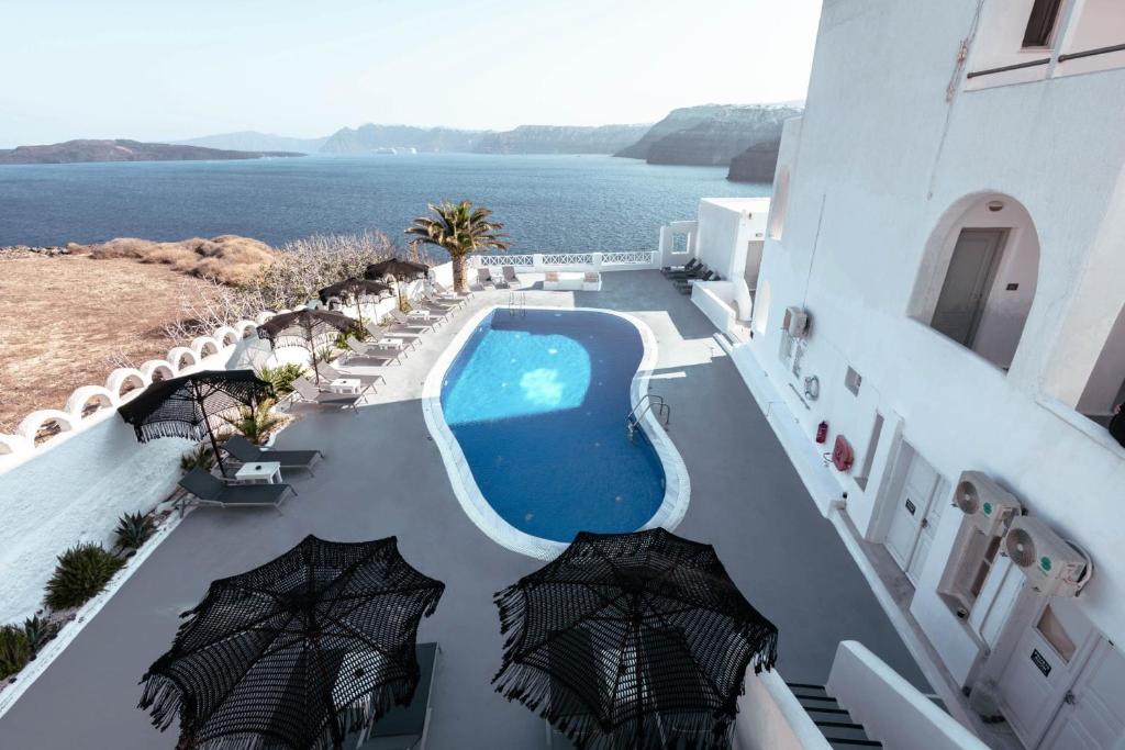 an aerial view of a hotel with a pool and umbrellas at Santorini View in Akrotiri