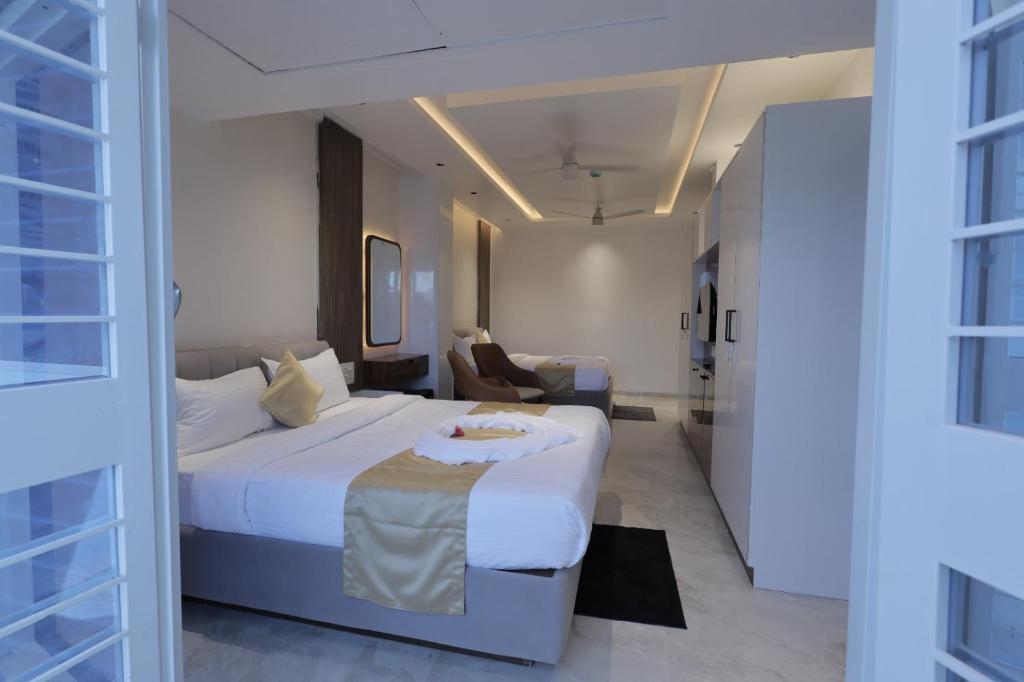 a hotel room with a bed and a living room at Hotel Krushnai Deluxe in Nandre