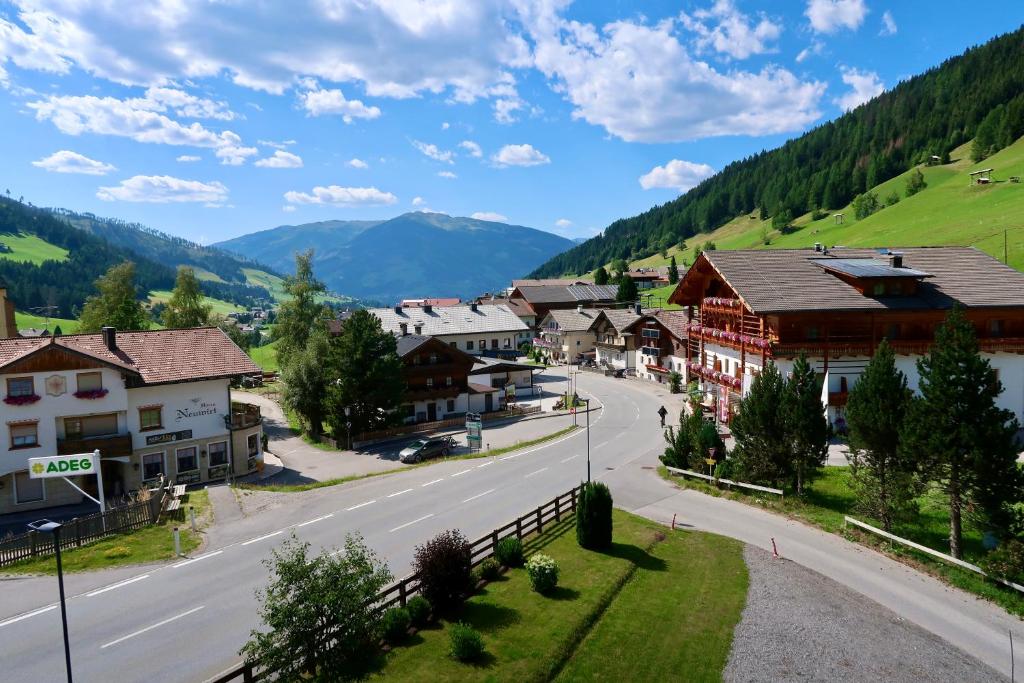 a town in the mountains with a road and houses at Haus Bodner in Kartitsch