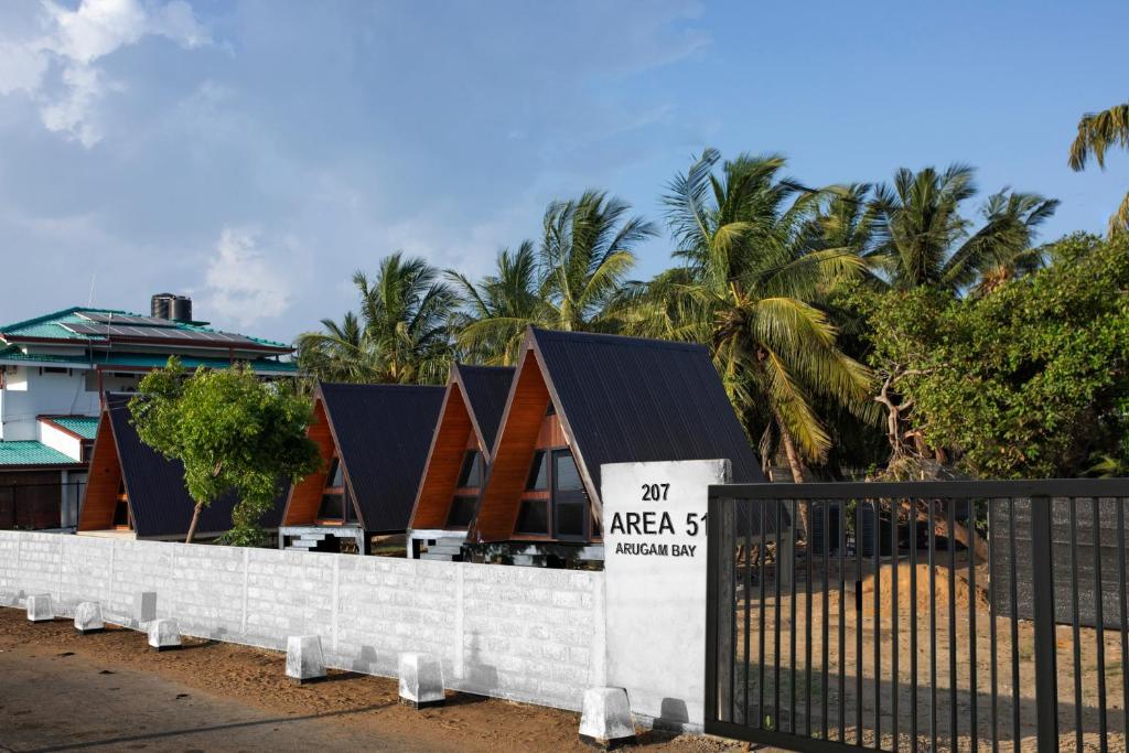 a sign on a fence in front of a house at Area 51 Arugambay in Arugam Bay