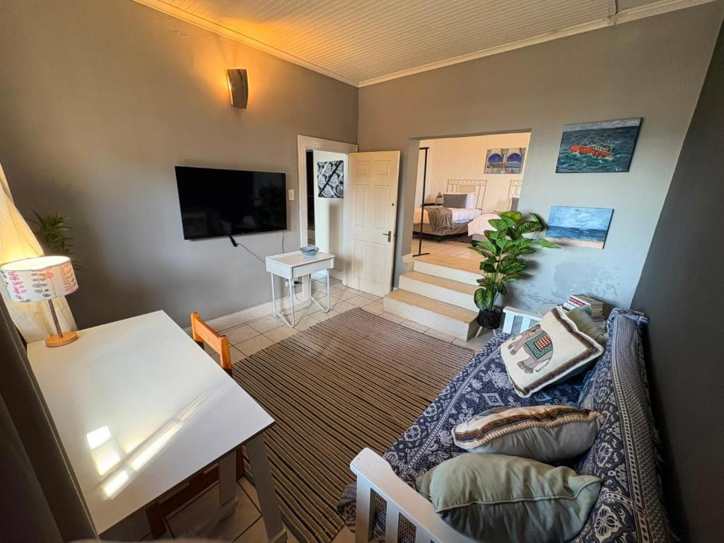 a living room with a couch and a table at The Sync Inn in Gqeberha
