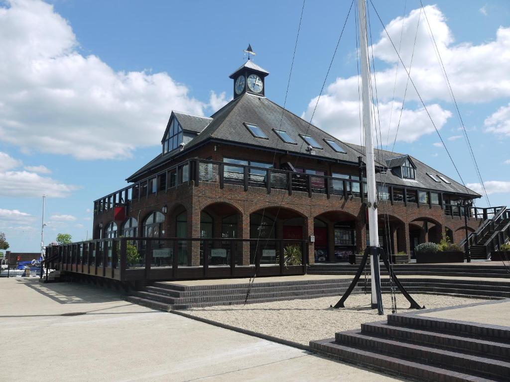 a building with a clock tower on top of it at Boathouse Hotel in Hythe