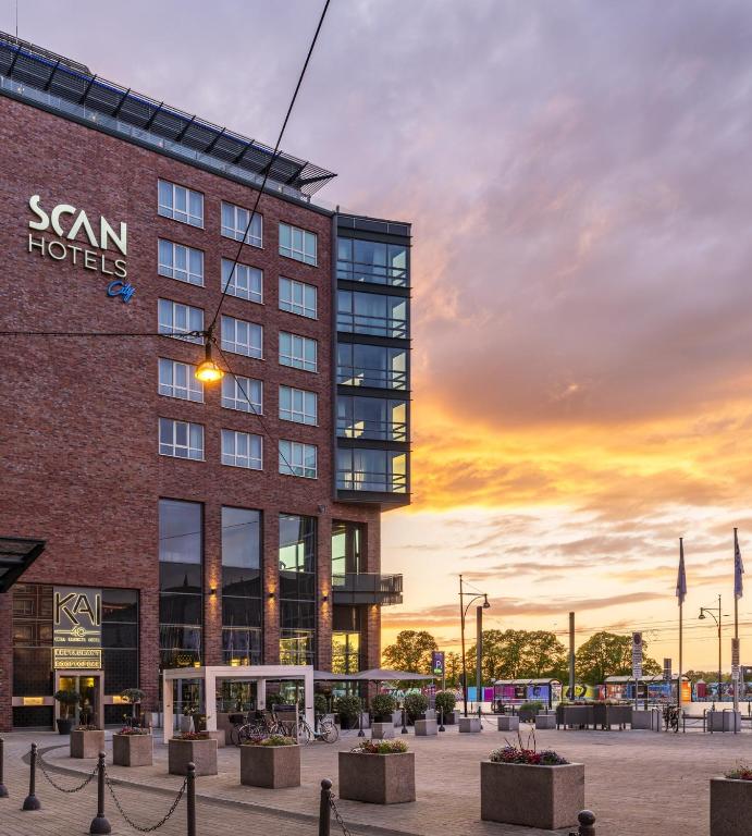a rendering of a hotel with a sunset in the background at ScanHotels City in Rostock