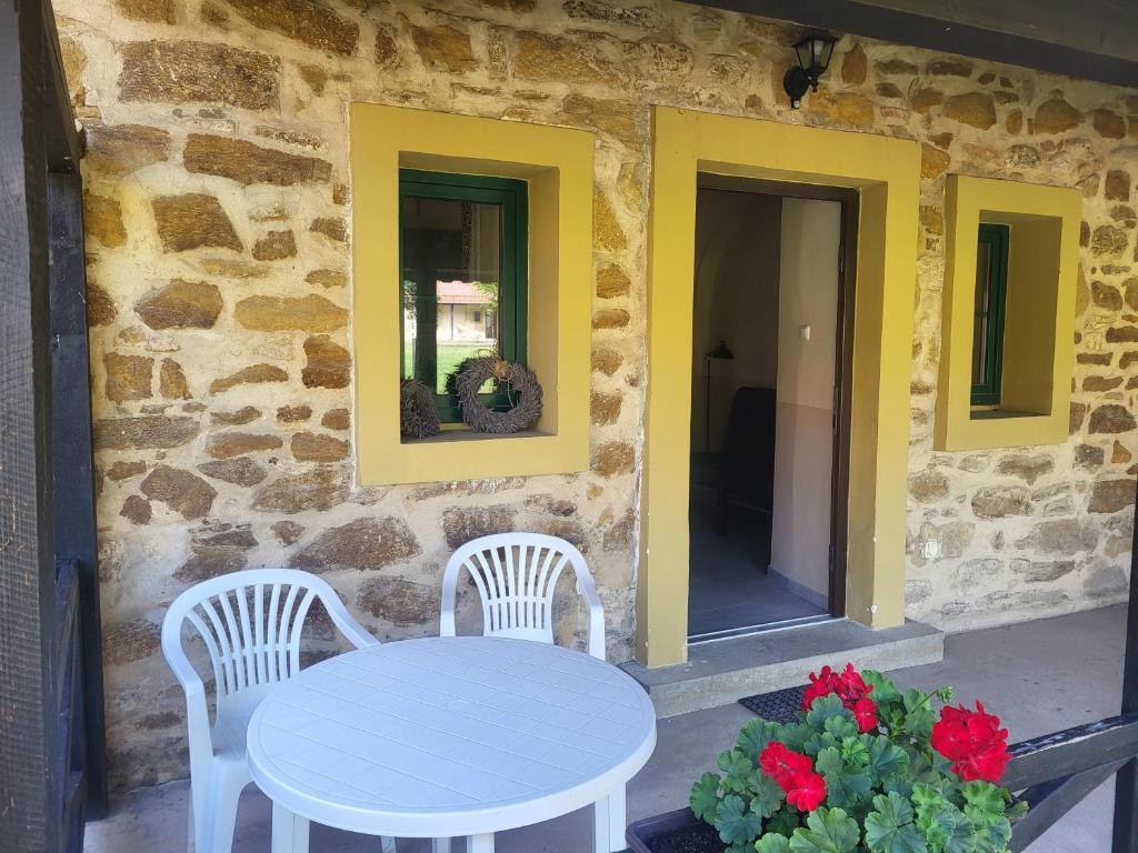 a white table and two chairs on a patio at ubytovaní na statku 