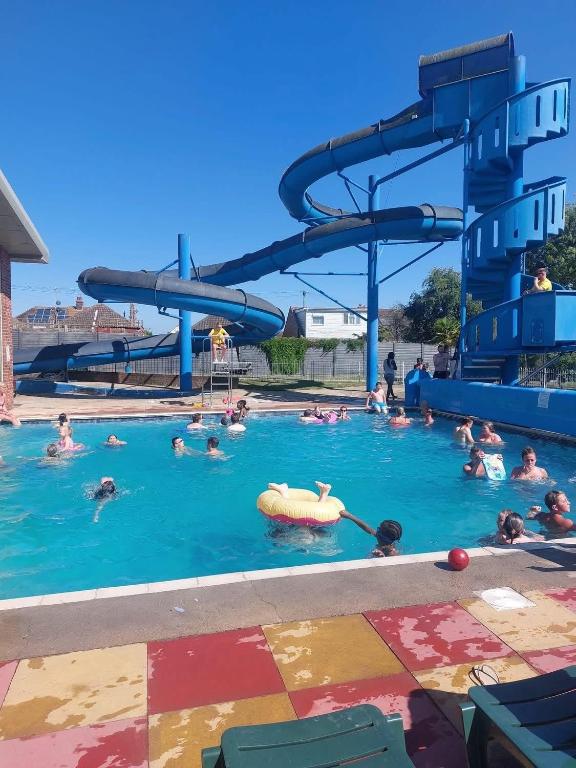 a group of people in a pool at a water park at Family friendly caravan park in Little Clacton