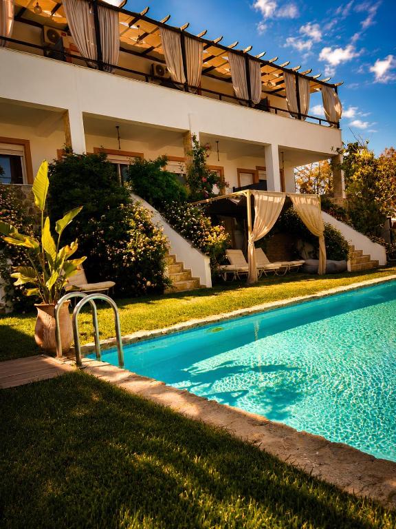 a swimming pool in the yard of a house at Irene's Maisonette at Rafaella Resort in Kokóni