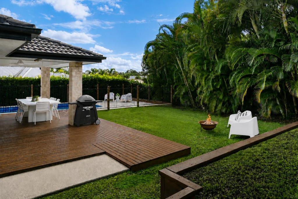 a backyard with a wooden deck and a grill at Blue Gum Hideaway Pet friendly Fire Pit in Coolum Beach