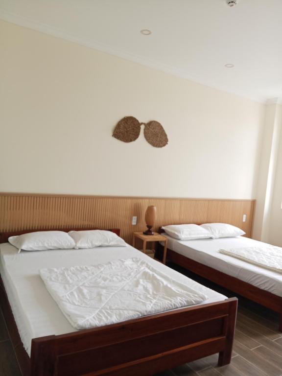 two beds sitting next to each other in a room at Homestay Kim Thuy in Hiếu Xương