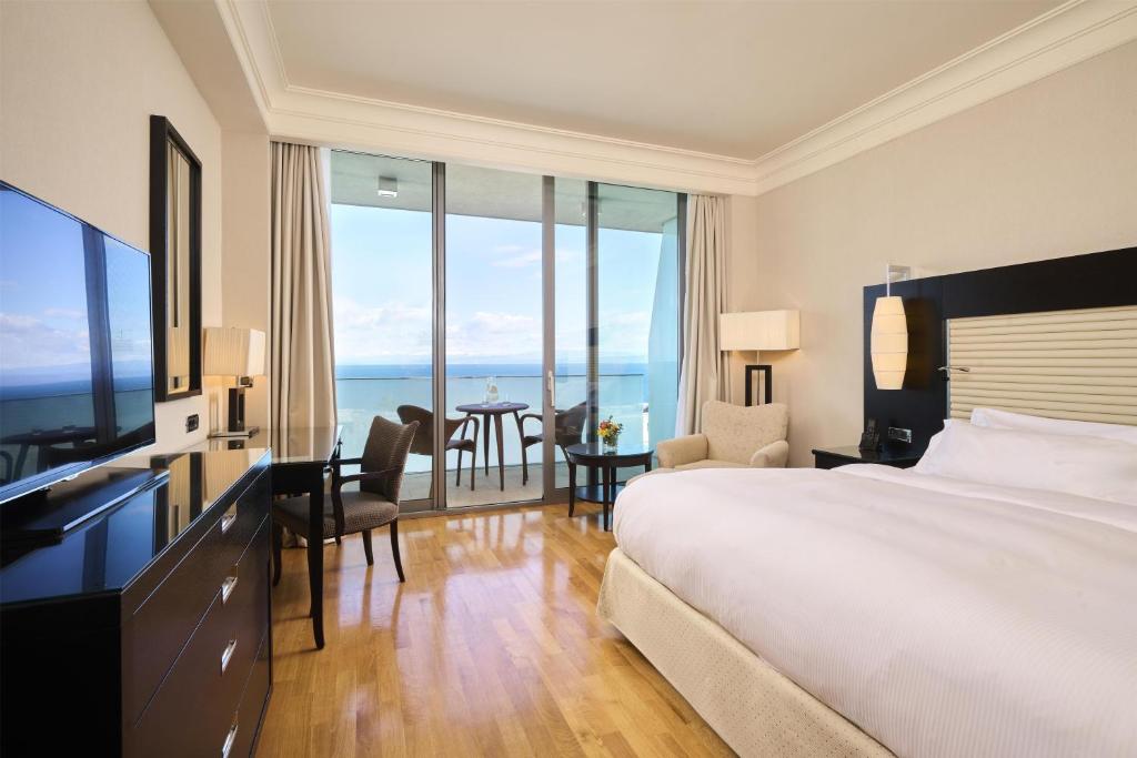a hotel room with a bed and a view of the ocean at Adriatic Istria Resort by Minor Hotels in Savudrija