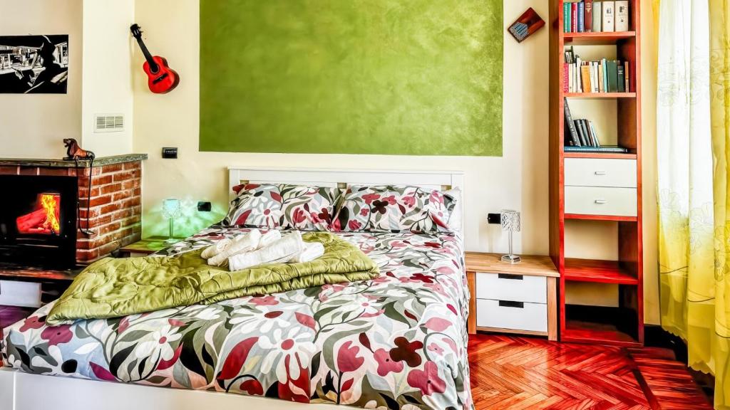 a bedroom with a bed and a fireplace at Moon's House Oropa in Biella