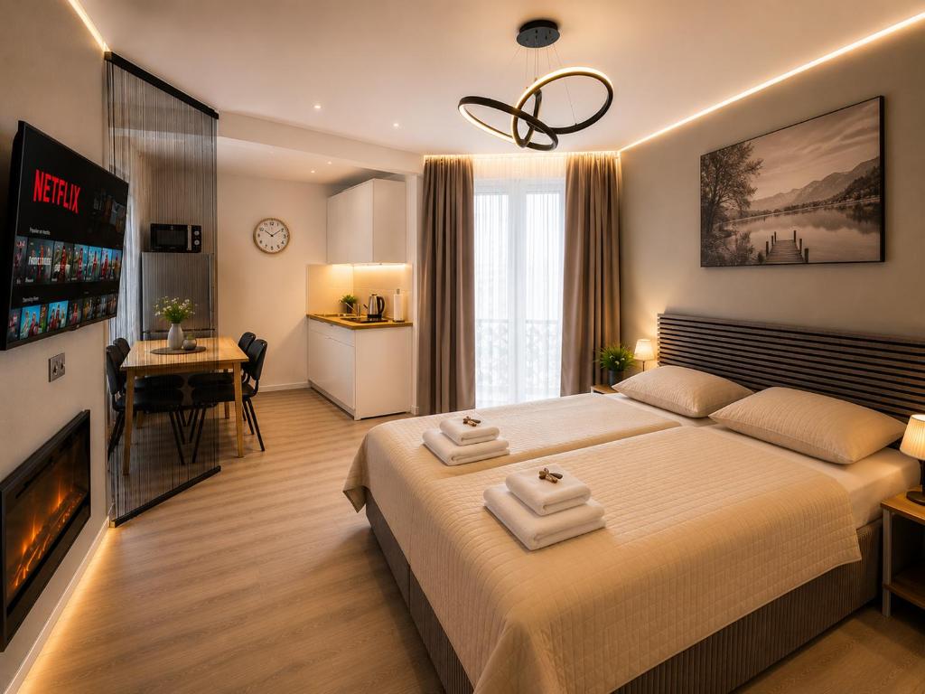 a bedroom with a large bed and a fireplace at Apartment Hotel in Nuremberg