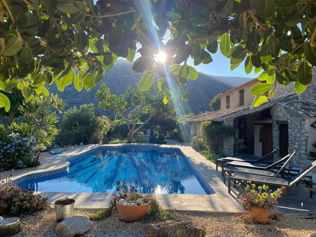 a swimming pool in front of a house at Casa de la Suerte in Benissa