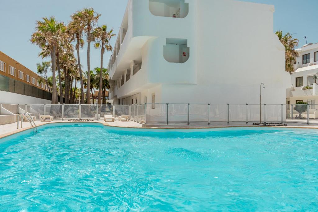 a large swimming pool next to a building at Brisa Marina by Maja FTV Ocean View in Antigua