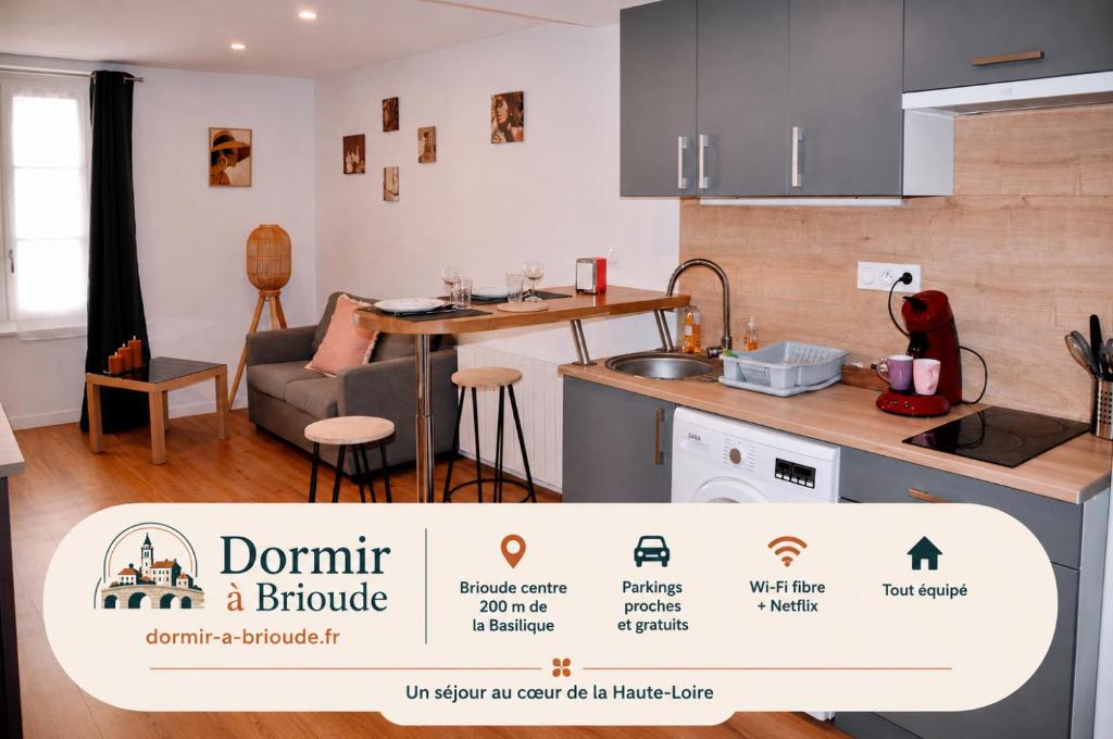 a kitchen and living room with a table and a couch at Dormir à Brioude - appartement 'esprit dune' in Brioude
