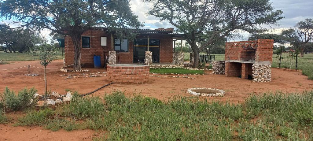 a brick house in the middle of a field at 4BFarming Rest camp and Camping in Naris