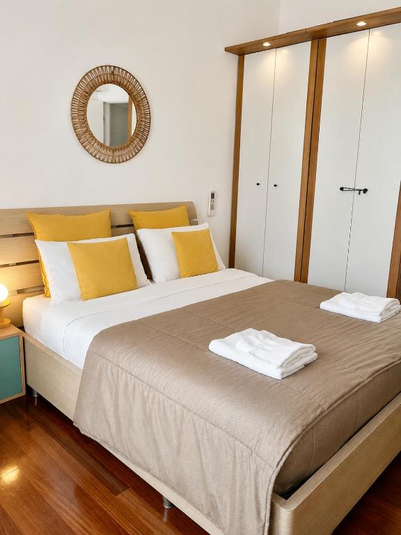 a bedroom with a large bed with yellow and white pillows at MilanoView Apartment in Milan