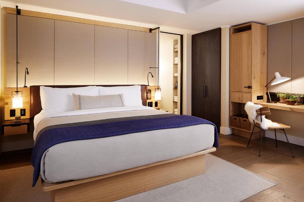a bedroom with a large bed and a desk at 1 Hotel Central Park in New York