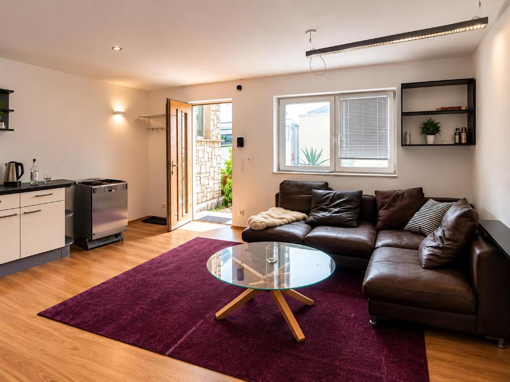 a living room with a leather couch and a glass table at Gemütliche Ferienwohnung in Burgberg in Giengen an der Brenz