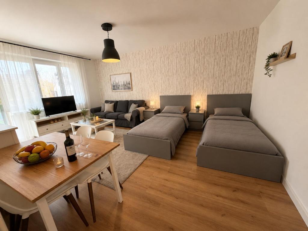 a living room with two beds and a table at Köln Pulheim Wellness Oase in Pulheim