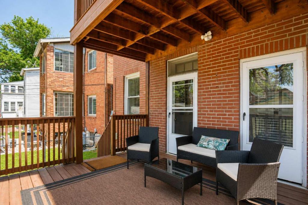 a patio with two chairs and a table on a porch at Historic 2BR with Deck Games & Garage in Saint Louis