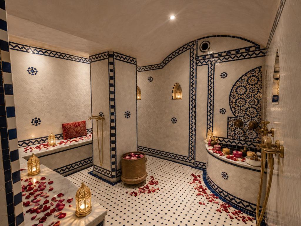 a bathroom with a shower and a tub and a bath tub at Riad Fes Colors & SPA - Family Lodging in Fez