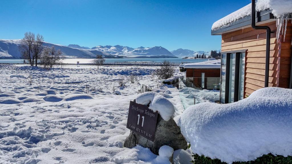 a sign in the snow in front of a building at Lakeview Tekapo in Lake Tekapo