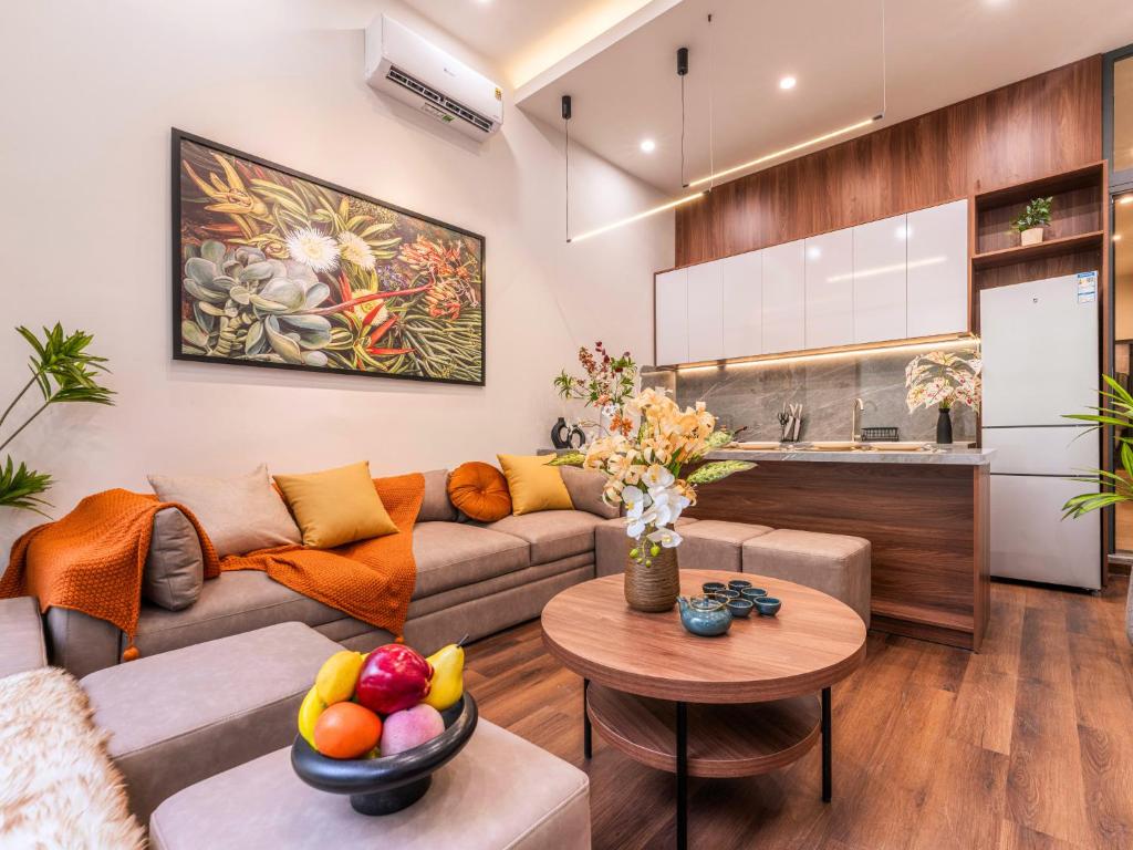 a living room with a couch and a table at Gon De Home Ham Nghi in Ho Chi Minh City